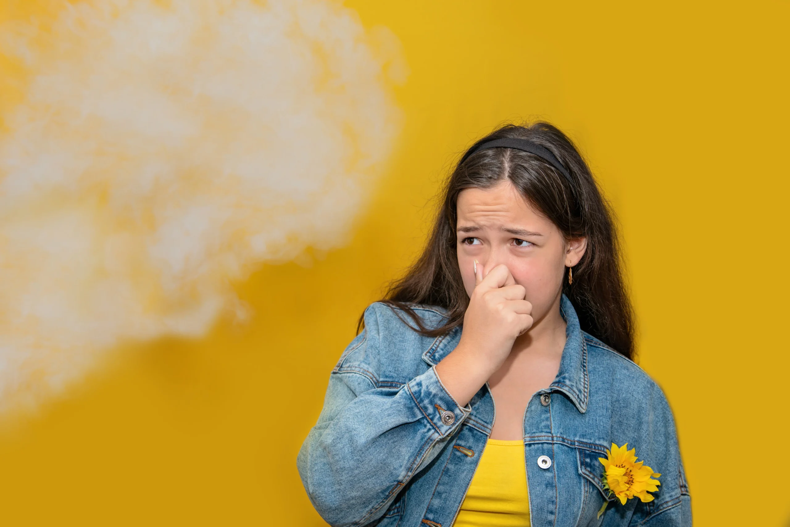 girl holding her nose