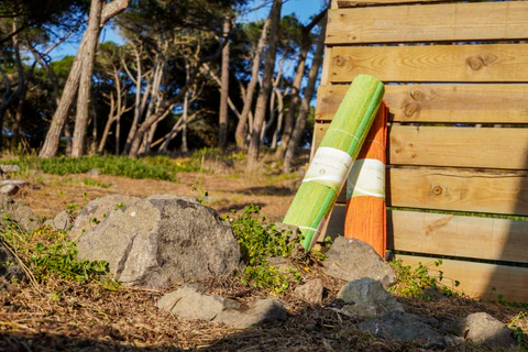 green and orange rolled up cottonyoga mat