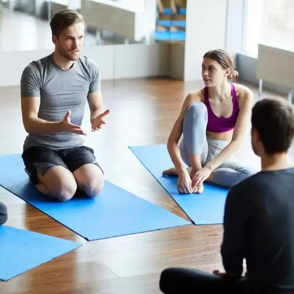 young man asking question at yoga